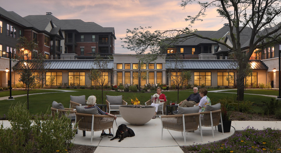 The Arboretum Villas Senior Living at Dusk sitting by the Firepit in the Courtyard